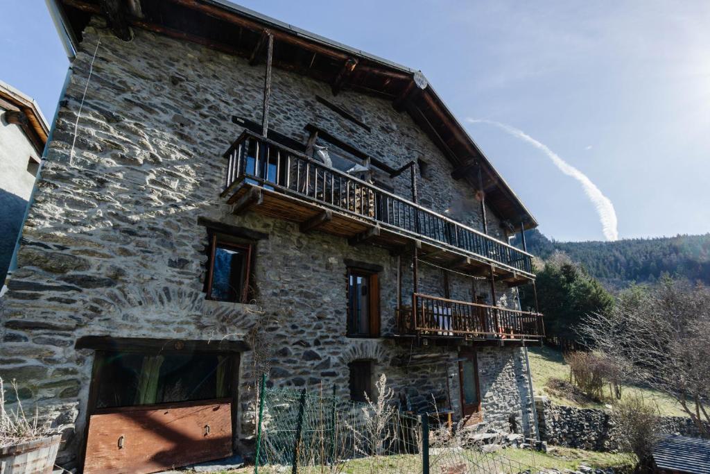 an old stone building with a balcony on it at Grand Chalet Vanoise - 12 pers in Saint-André