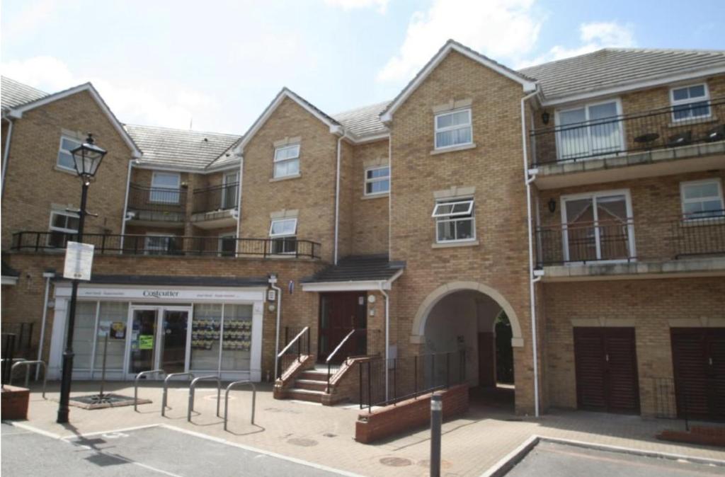an apartment building with a staircase in front of it at Peaceful Retreat in Basildon - Relocators & Contractors Welcome in Great Burstead