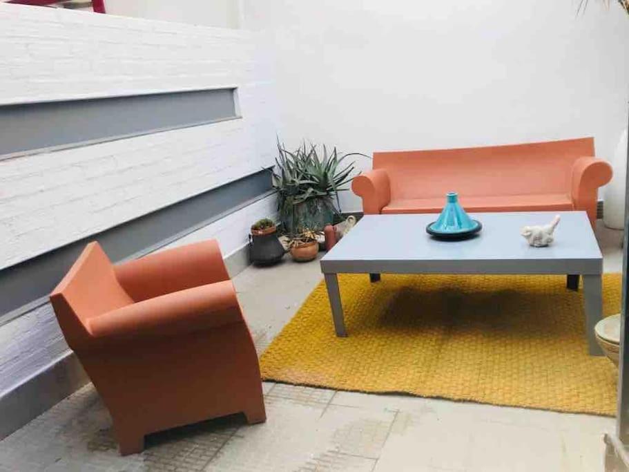 a patio with a bench and a table and a chair at 70m2 Loft with Patio only 20mn from Plaza Castilla C2 in Madrid