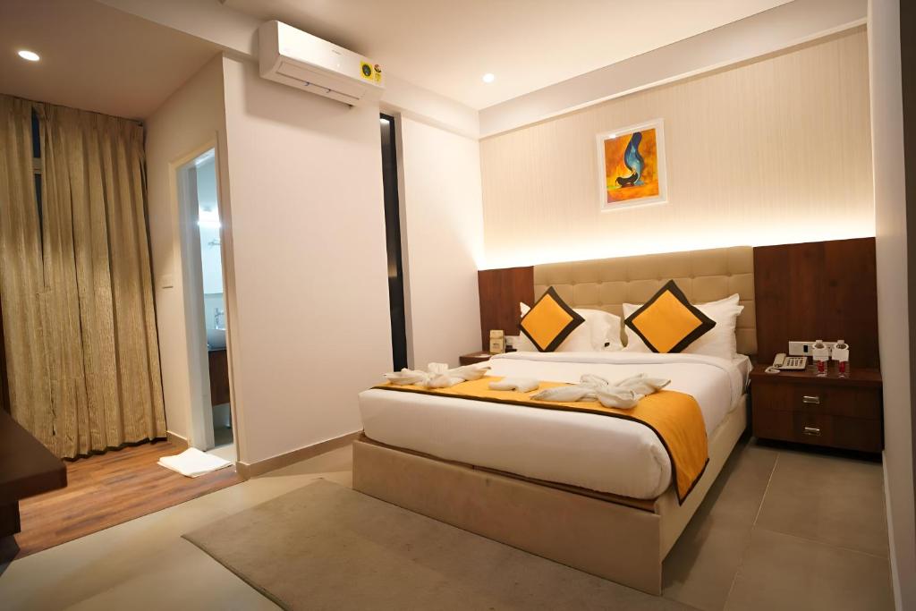a bedroom with a large bed in a room at La Serene Business Hotel in Bangalore