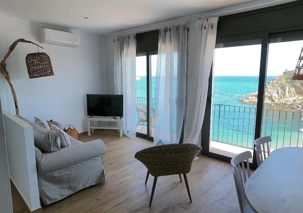 a living room with a view of the ocean at Hostal Sa Malica in Blanes