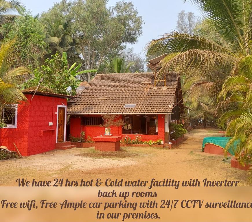 a red house with a sign in front of it at Samarth Atc-Beach Home Stay in Ratnagiri