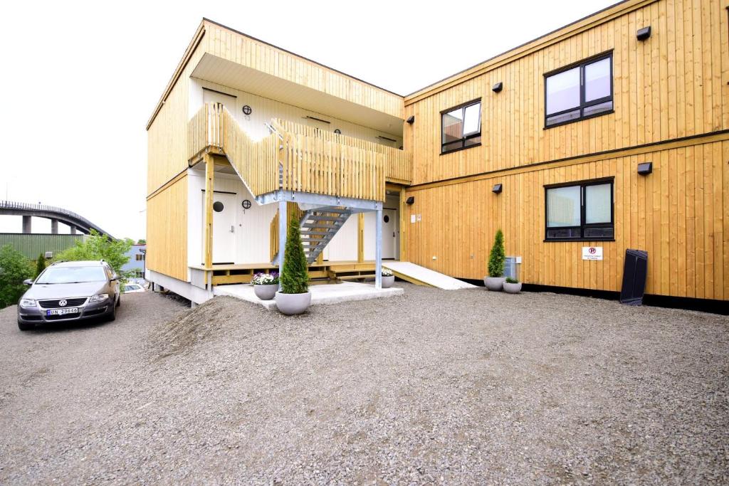 a house with a car parked in front of it at Vestfjordgata apartment 15 in Svolvær