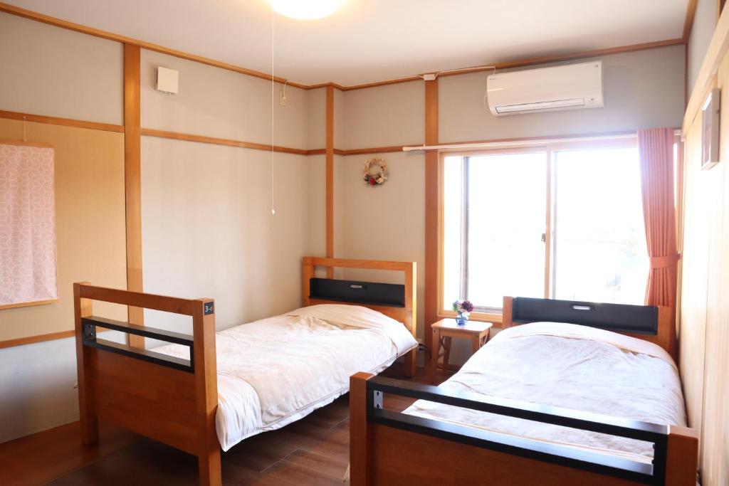Postel nebo postele na pokoji v ubytování Ise Guest House Sora
