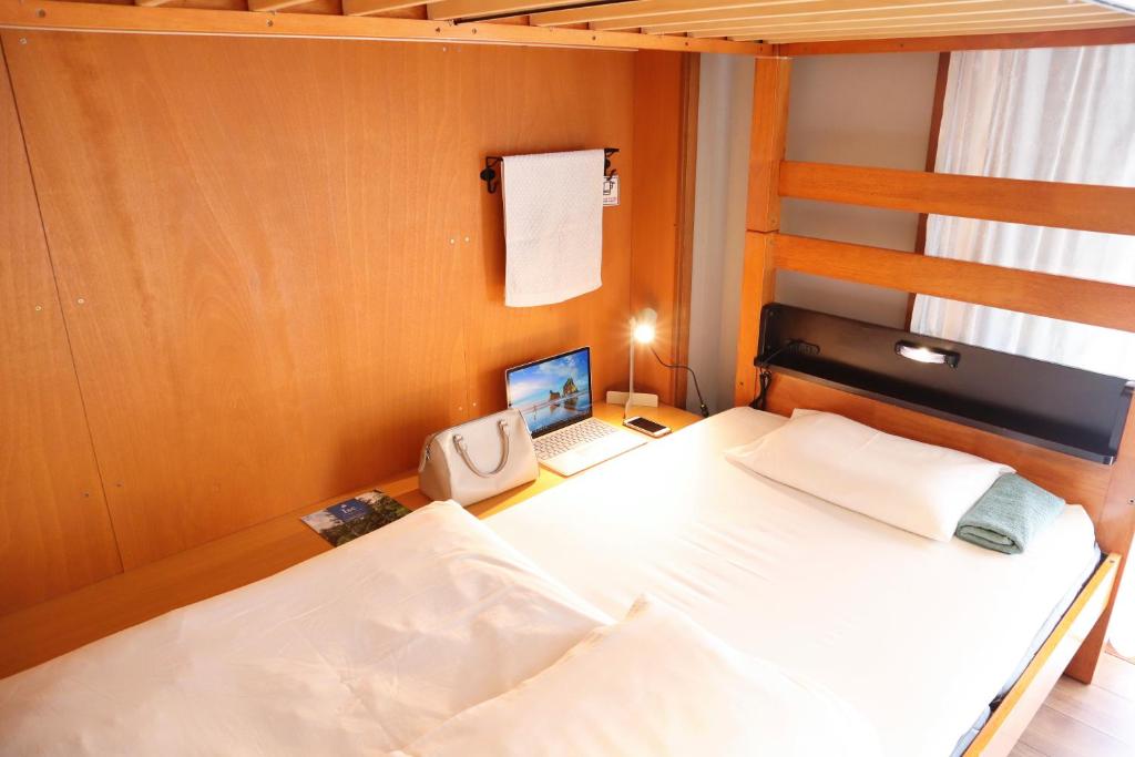Postel nebo postele na pokoji v ubytování Ise Guest House Sora
