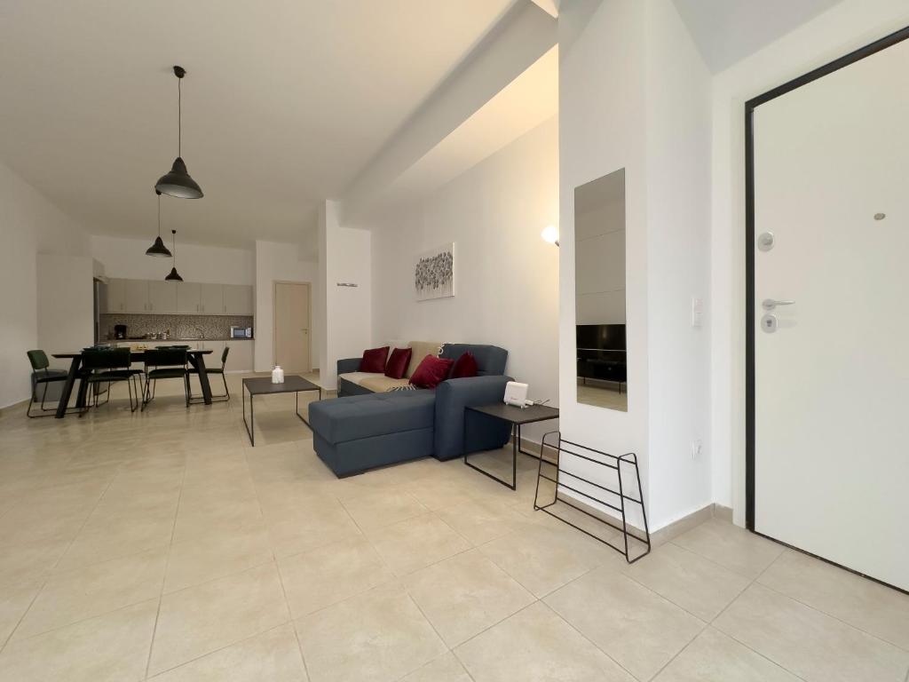 a living room with a blue couch and a table at Glenvar Heights I1 90 sqm apt in Paleo Faliro in Athens
