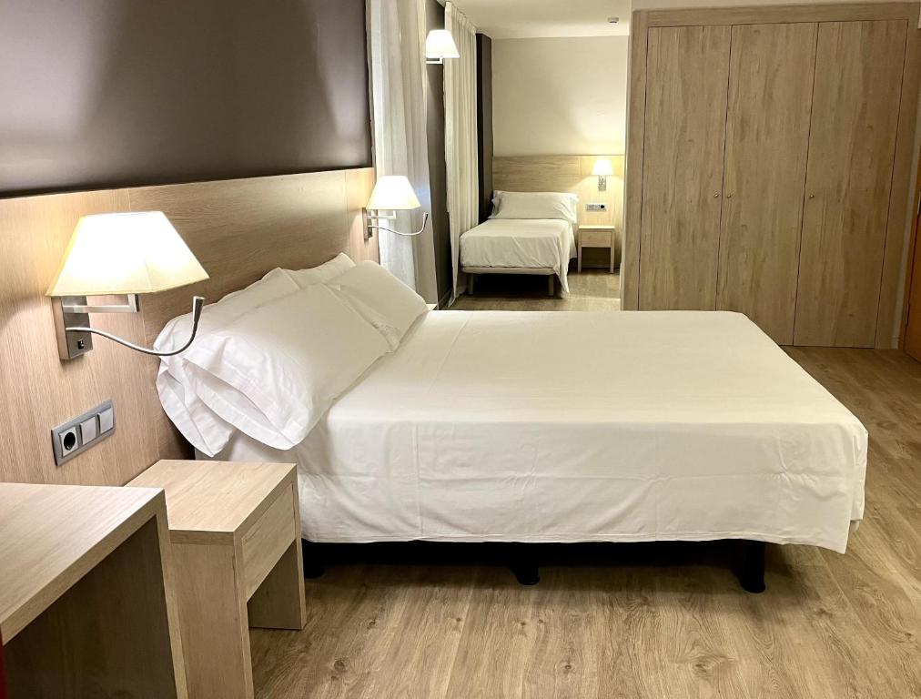 Postel nebo postele na pokoji v ubytování Balneari Termes Victòria