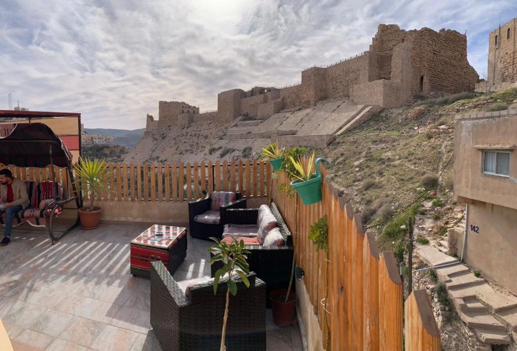 a patio with couches and a view of a castle at Bubble castle house in Kerak