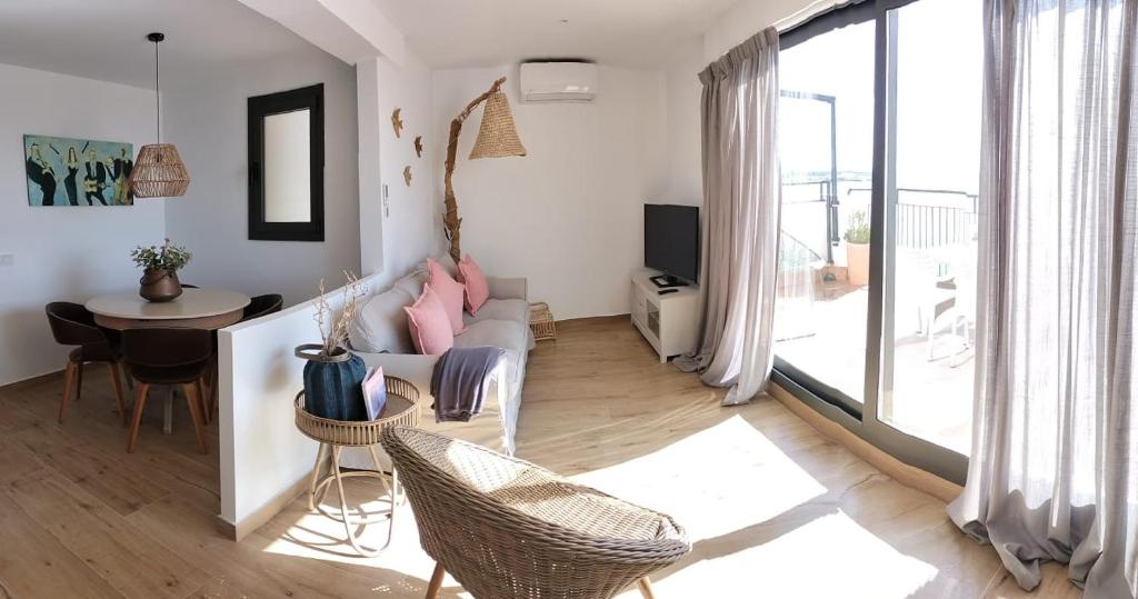 a living room with a couch and a table at Hostal Sa Malica in Blanes