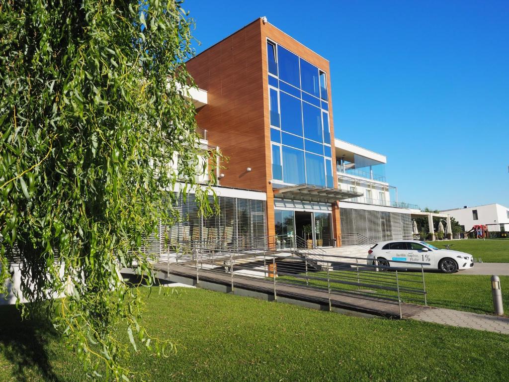 a building with a car parked in front of it at Hotel Ponteo - Activity Park in Bratislava