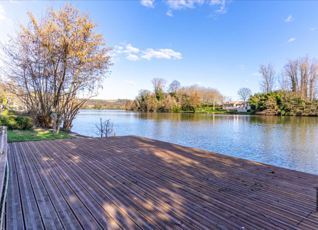 - un quai en bois avec vue sur la rivière dans l'établissement Riverside Gîte Pinel Hauterive, à Pinel-Hauterive