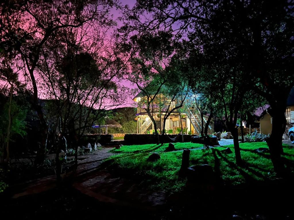 a night view of a park with trees and grass at Kolobeng Valley in Ranku