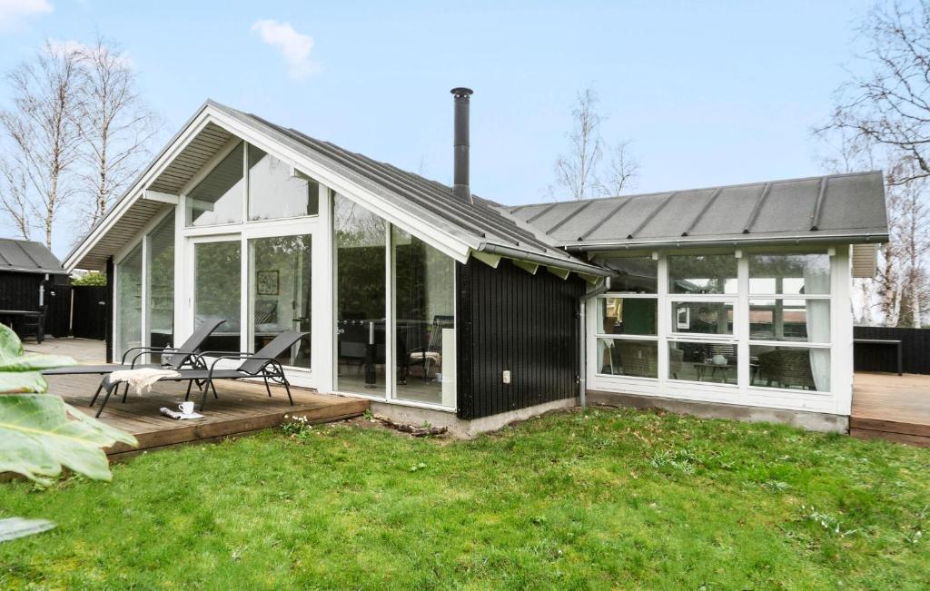 ヒュールスミンネにあるStunning Home In Juelsminde With 2 Bedrooms And Wifiの黒と白の家(ベンチ付きのデッキ付)