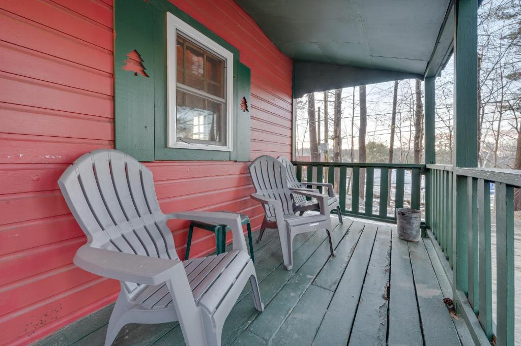 two chairs sitting on the porch of a house at Cozy Laconia Studio with Pool Access - 2 Mi to Lake! in Laconia