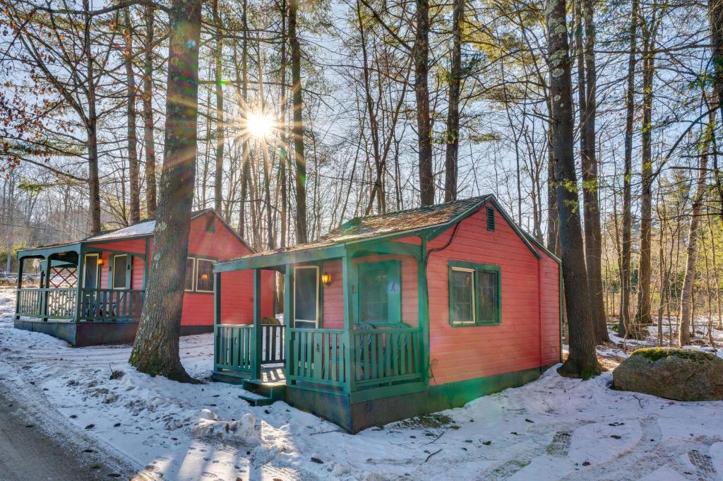 two tiny houses in the woods in the snow at Quiet Laconia Studio, Near Mill Falls Marketplace! in Laconia