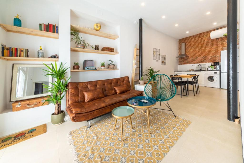 a living room with a leather couch and a table at 2 bedrooms 1 bathroom furnished - Lavapies - Modern Cozy - MintyStay in Madrid