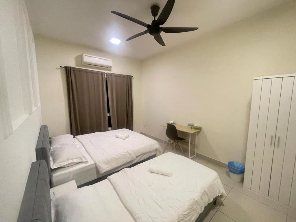 a bedroom with two beds and a ceiling fan at Charming Hideaway Room With Private Bathroom Near Bukit Jalil Stadium, Pavillion Bukit Jalil, APU in Kuala Lumpur