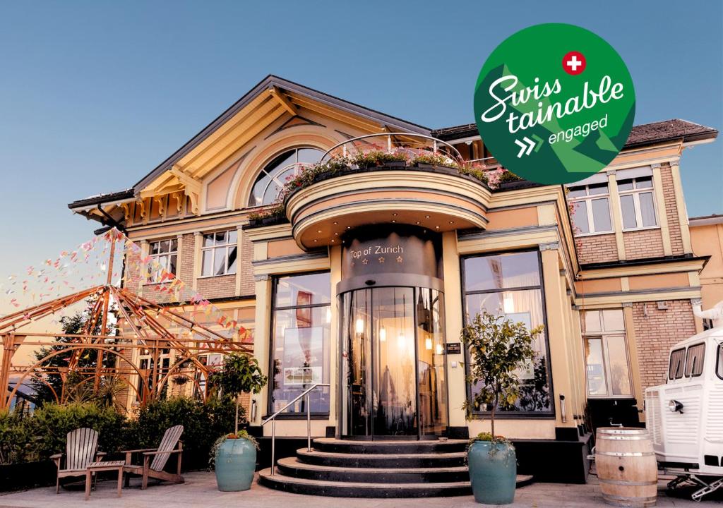 a house with a sign on the front of it at Hotel UTO KULM car-free hideaway in Zurich in Zurich