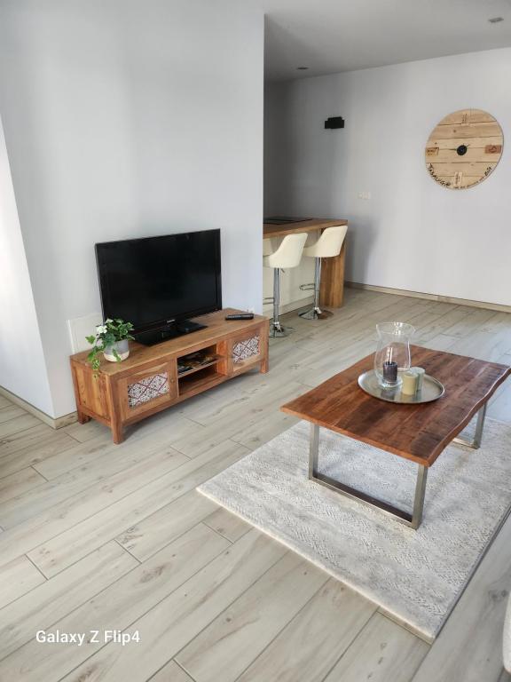 a living room with a tv and a coffee table at Alt trifft Neu in Bad Neuenahr-Ahrweiler