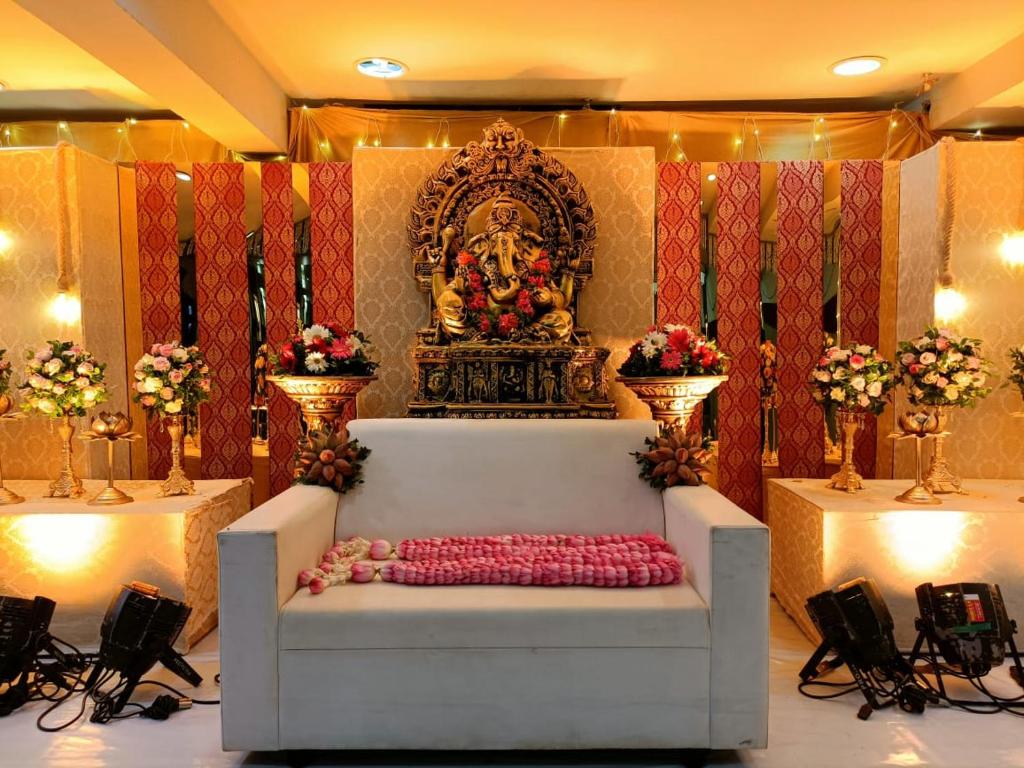a altar with a statue in the middle of a room at Hotel Mangala Temple View in Guruvāyūr