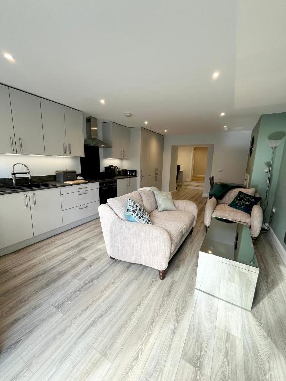 a living room with a couch and a kitchen at Mary McGill’s in Ballycastle