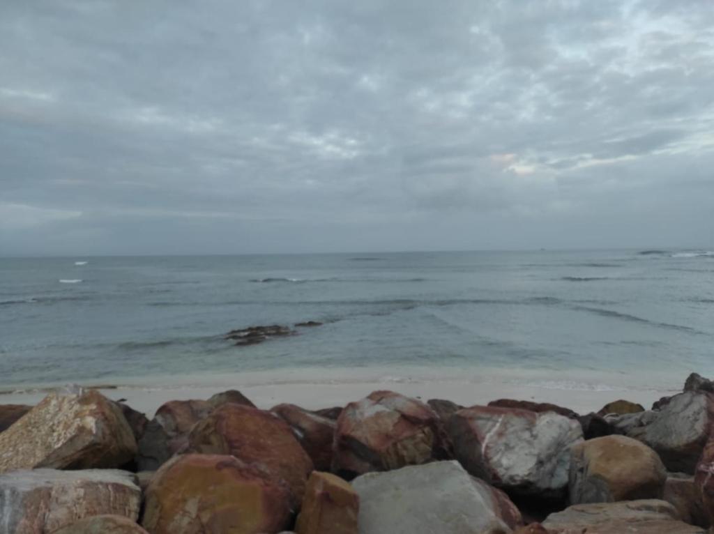 a pile of rocks on the beach near the water at Guest Suite 1 at Rustic Dune in Jeffreys Bay