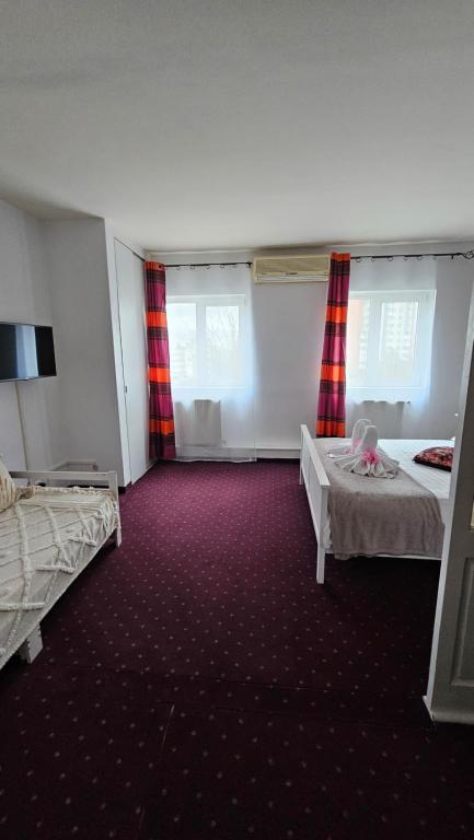 Postel nebo postele na pokoji v ubytování Hotel Olimp