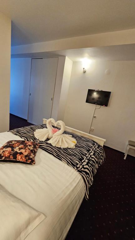 Postel nebo postele na pokoji v ubytování Hotel Olimp