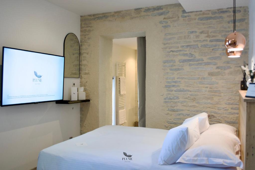 Postel nebo postele na pokoji v ubytování Plume Suites