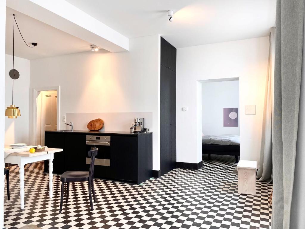 a room with a black and white checkered floor at zehuus - historical charm 70qm in Cologne