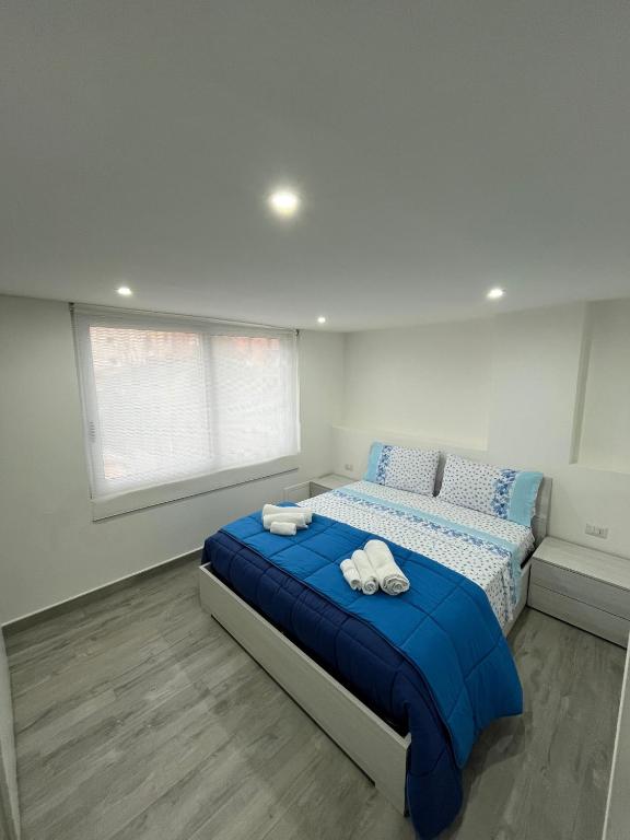 a bedroom with a bed with towels on it at Monolocale "Sula" in Agropoli