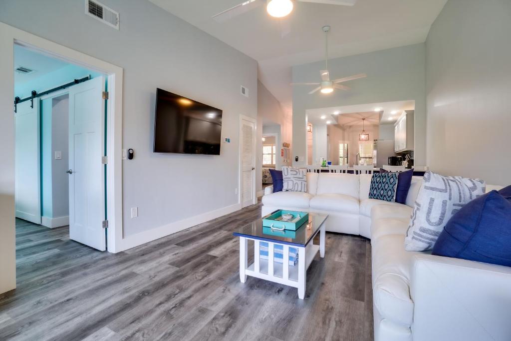 a living room with a white couch and a table at Luxury 2 bed and 2bath Lakefront Condo Near IMG and Anna Maria Island in Bradenton