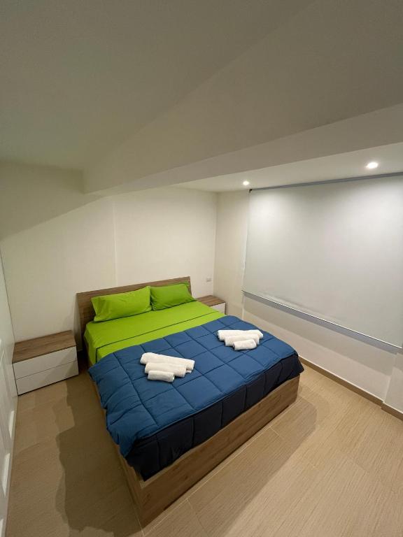 a bedroom with a bed with two towels on it at Monolocale "Raja" in Agropoli