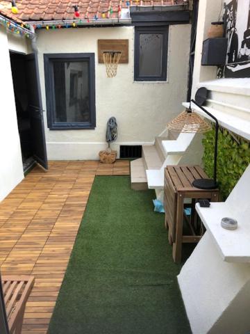 - un balcon d'une maison avec un tapis vert dans l'établissement Amienoise centre ville, à Amiens
