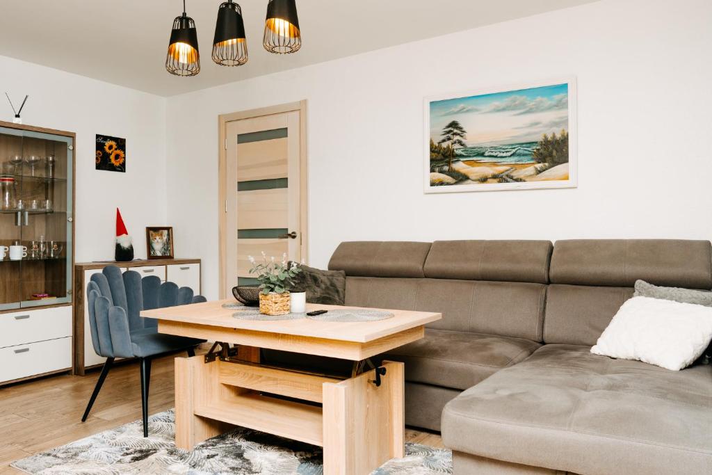 a living room with a couch and a table at Mano jūra in Palanga