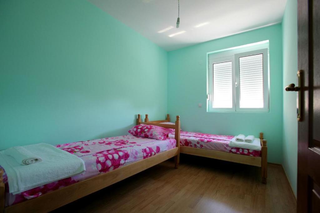 Postel nebo postele na pokoji v ubytování Apartments Hots