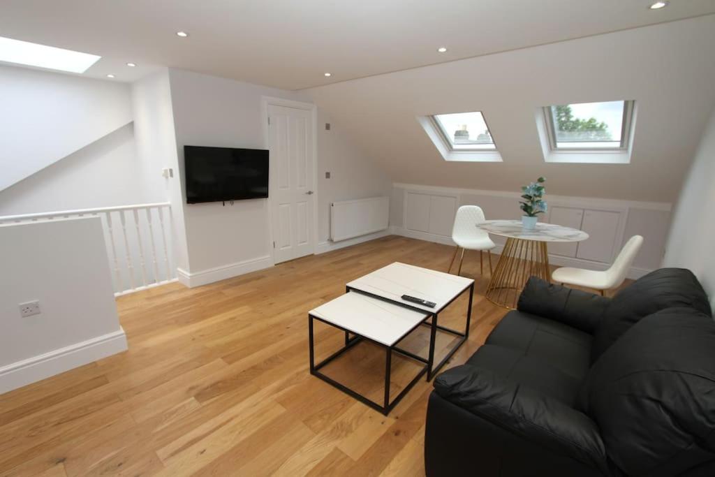 a living room with a couch and a table at Amazing Loft One Bedroom Apartment - E17 Village in London