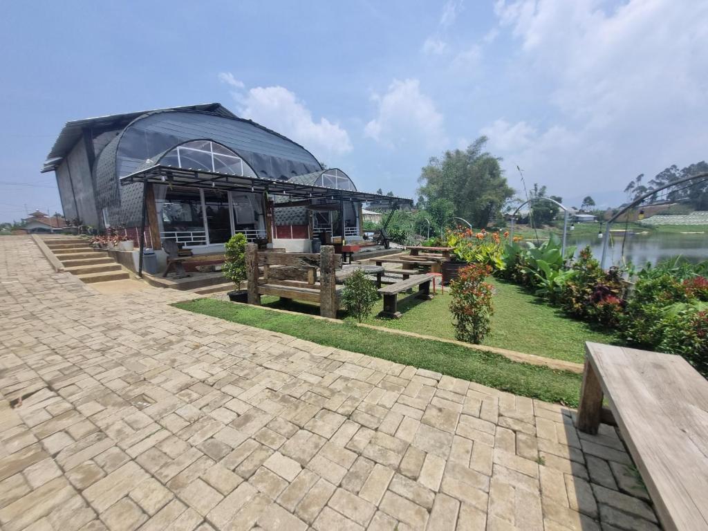 a building with a pavilion next to a body of water at Kampung Panorama in Pengalongan