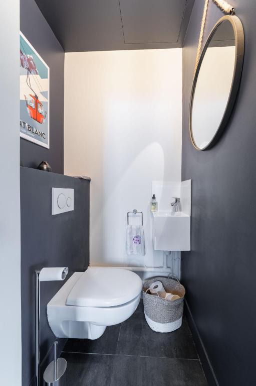 a bathroom with a white toilet and a mirror at Wonderful luxury house at 10min from Paris in Meudon