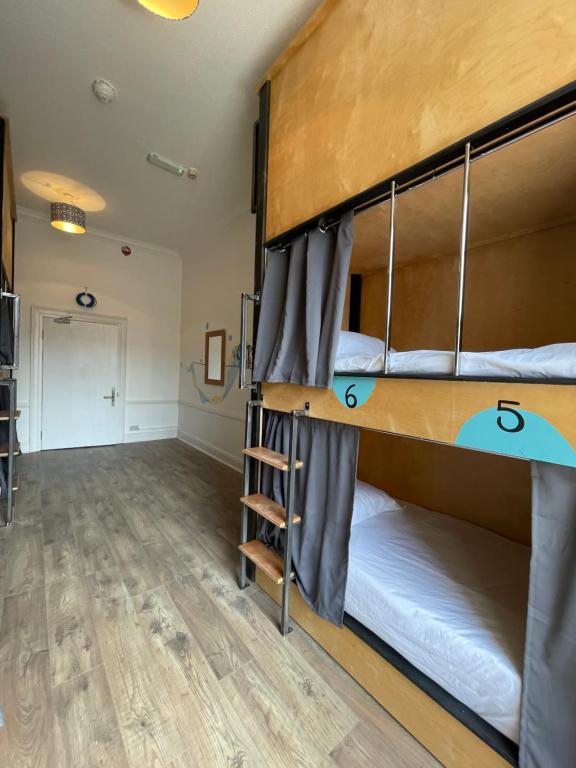 a room with two bunk beds and a hallway at Leevin Hostel George in Dublin