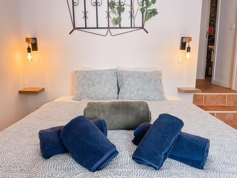 a bedroom with a bed with blue pillows on it at Old Fisherman's Corner 12 - Centro Old Town Albufeira in Albufeira