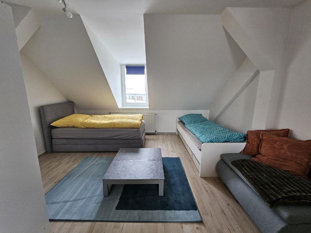 a living room with two beds and a couch at Apartmenthaus Delitzsch 1-2 Zimmer Apartments in Delitzsch