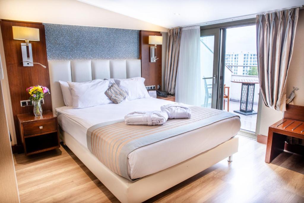a bedroom with a bed with two towels on it at Grand Aras Hotel & Suites in Istanbul