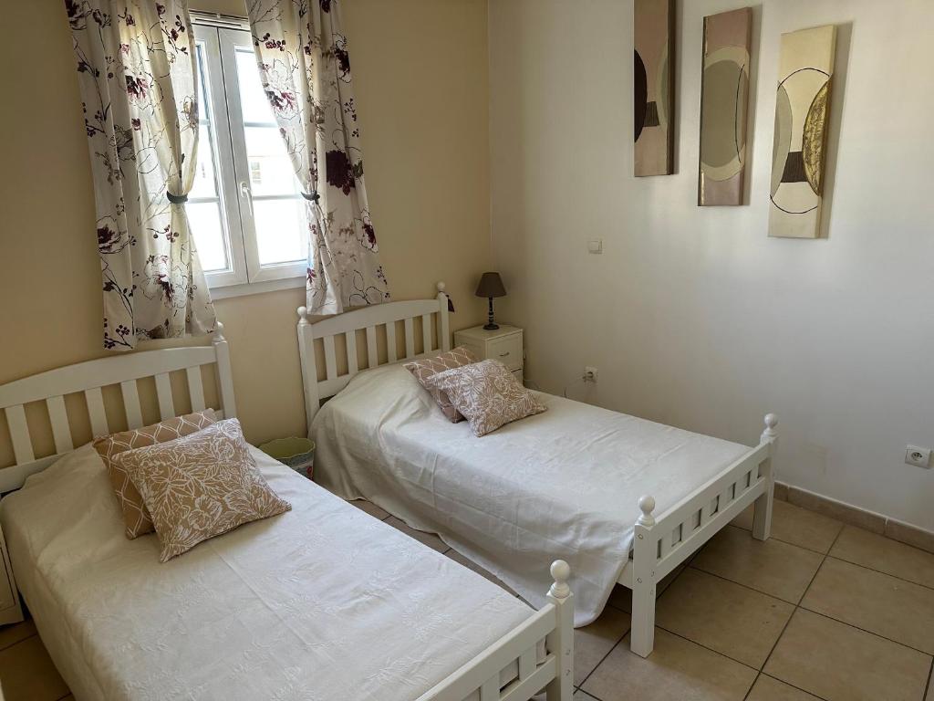 a bedroom with two beds and a window at Marina Ivoire in Aigues-Mortes
