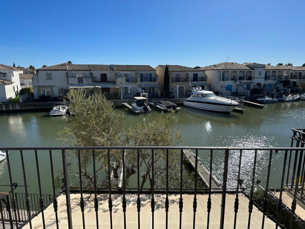 a view of a river with boats and buildings at Marina Ivoire in Aigues-Mortes