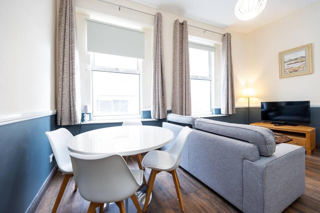 sala de estar con sofá, mesa y sillas en Homely 1 bedroom apartment in Smithfield, Dublin, en Dublín