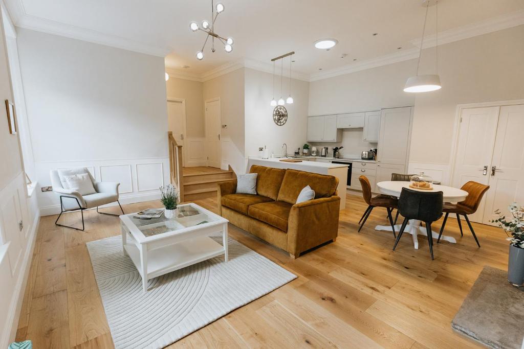 een woonkamer met een bank en een tafel bij WENSLEYDALE, OLD SCHOOL ROOMS - Ground Floor Luxury Apartment in Richmond, North Yorkshire in Richmond