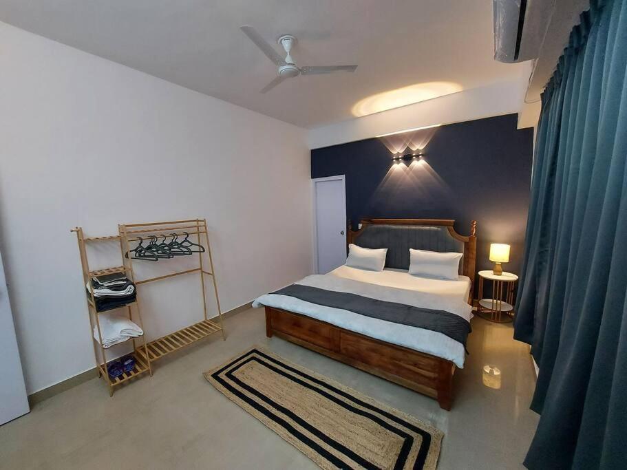 a bedroom with a bed and a blue wall at Skyline 2BHK Independent flat in Lucknow