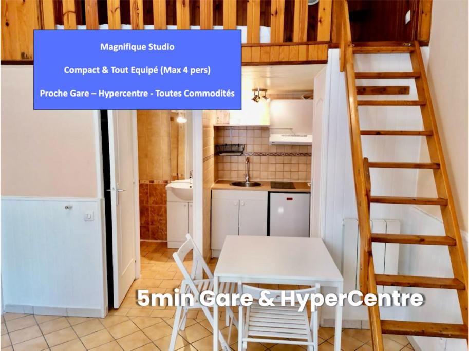 a small kitchen and a staircase in a tiny house at Sublime Studio - Centré & Tout Equipé in Grenoble