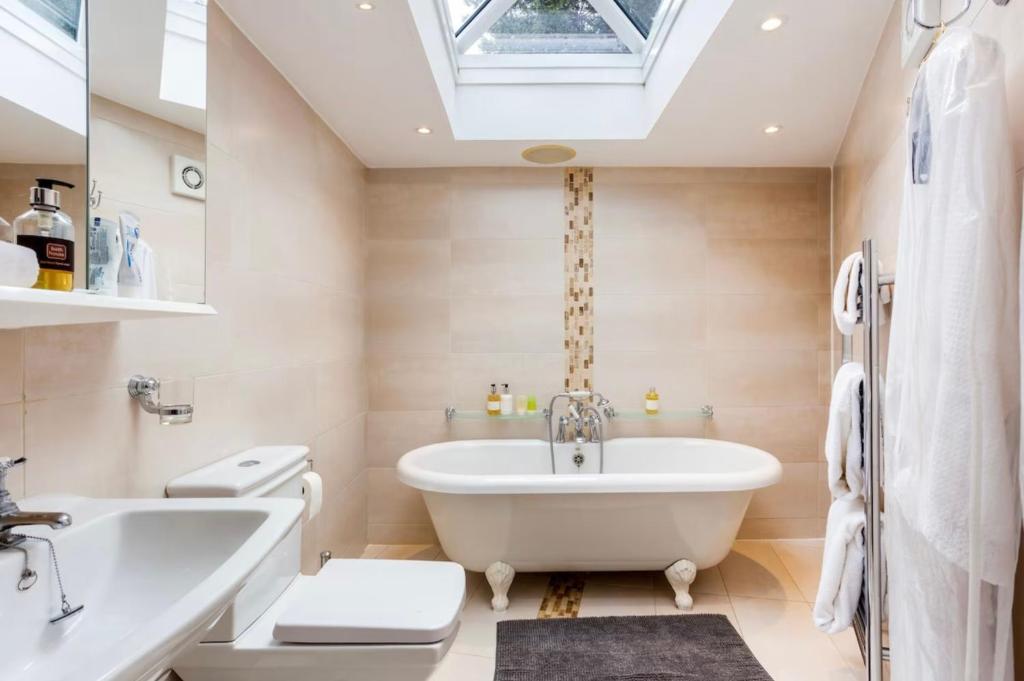a bathroom with a white tub and a sink at Byford Lodge Luxury self-catering in Louth in Louth